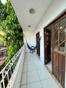 a hammock on the balcony of a house at Residencial Ribeiro in Salvador +5 photos