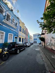 a street with cars parked on the side of the road at Residencial Ribeiro in Salvador