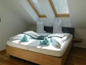 a bed with blue and white pillows on it at Flat in Hohentauern near the ski area in Hohentauern