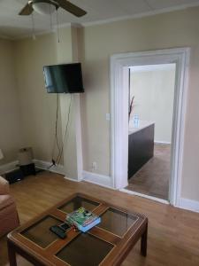 a living room with a coffee table and a television at Cozy downtown two bedrooms free parking in Kingston