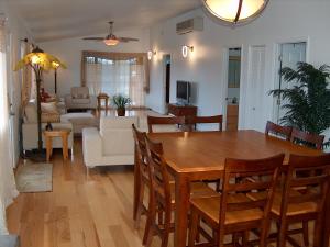 a dining room and living room with a table and chairs at Itʻs All About the Beach in Hauula