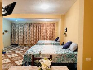 a bedroom with two beds and a large window at Casa Nicolas #1 in San Pedro La Laguna