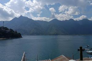 a view of a large body of water with mountains at Casa Nicolas #1 in San Pedro La Laguna