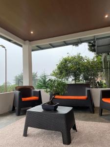 un patio con sillas y una mesa con una maceta en Casita Boquete, en Boquete