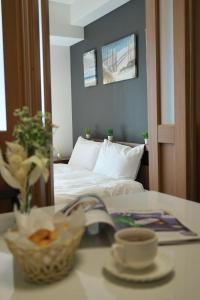 a bedroom with a bed and a table with a cup of coffee at The Peak Chiyozaki in Osaka