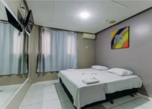 Voodi või voodid majutusasutuse Iapi Hotel toas