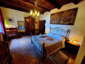 a bedroom with a bed and a mirror and a chandelier at Antica Locanda La Tinara del Belvedere - Romantic Dreams - in Galbiate