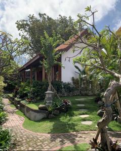 a garden in front of a house at Jinar Guest House in Canggu