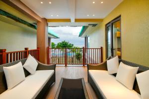 a balcony with couches and a view of the ocean at H Resort - The Coral Cliff in Calape