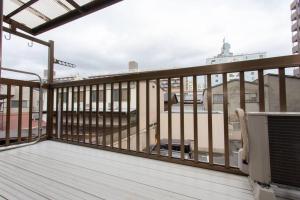 a balcony with a view of a building at Kanmuritei Guest House UP to 7 pax, 冠邸l和モダン最大7名まで宿泊可能 in Kyoto
