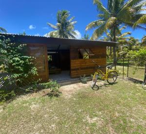 a yellow bike parked in front of a house at Fare Tahima in Fare