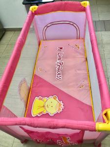 a pink crib with a hello kitty blanket at Livi beachfront Apartment in Durrës