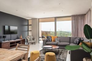 a living room with a couch and a table at 56 Zimbali Wedge in Ballito