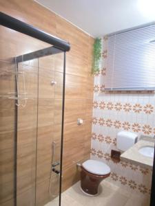 a bathroom with a toilet and a sink at Aton Plaza Hotel in Goiânia