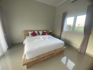 una camera da letto con un letto con lenzuola bianche e una finestra di D'A HOUSE ad Amed