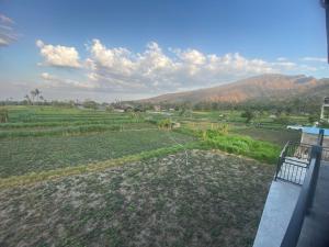 a view of a field with mountains in the background at D'A HOUSE in Amed +10 photos