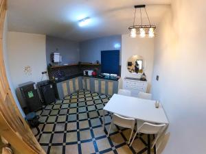 a kitchen with a table and chairs in a room at The Perfect Hideout in Yelahanka