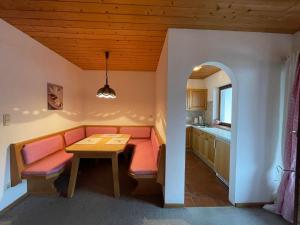a living room with a table and a dining room at Fleckalm Chalets in Kirchberg in Tirol