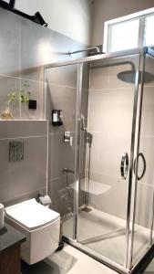 a bathroom with a shower and a toilet at V Hotels and Resorts in Chīrāla