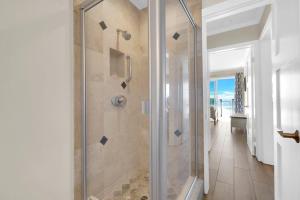 La salle de bains est pourvue d'une douche avec une porte en verre. dans l'établissement Seaview 1133A, à Oceanside
