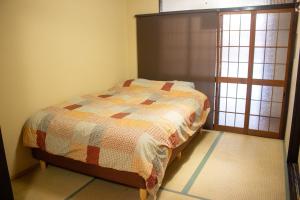 Ένα ή περισσότερα κρεβάτια σε δωμάτιο στο Oyado Tofukuji