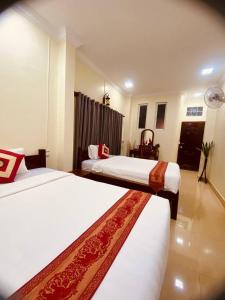 a hotel room with two beds in a room at Nika's House in Siem Reap