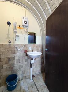 a bathroom with a sink and a shower at D' Limbai Cottage in Ranau
