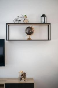 a shelf with a globe on top of a table at Villa Eden - Maison de ville au coeur de Menton, plage à 7 minutes in Menton