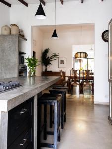 a kitchen with a large counter with stools at "27" Spathodea- Oasis in the City in Colombo