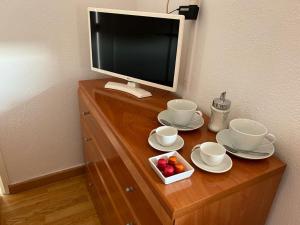 a computer monitor sitting on top of a wooden dresser at Casa Grabo in Cors