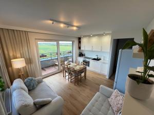 a living room with a couch and a table at Apartament Nowe Ogrody in Leszno