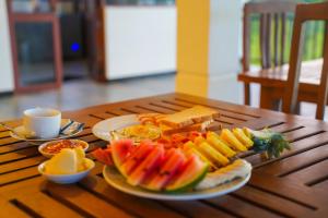 a wooden table with a plate of food on it at Sigiri Sierra View Resort in Sigiriya