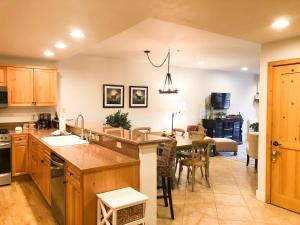 a kitchen with a counter and a dining room at Bear Creek Lodge 111A by Alpine Lodging Telluride in Telluride