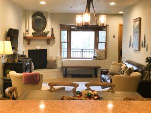 a living room with a table and a couch at Bear Creek Lodge 111A by Alpine Lodging Telluride in Telluride +15 photos