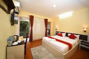 una camera da letto con un letto grande con cuscini rossi di Hotel Odyssey Nepal a Kathmandu