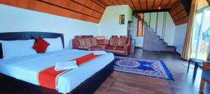 a bedroom with a bed and a living room at EagleRedCasino in Vagamon