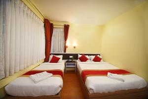 Letto o letti in una camera di Hotel Odyssey Nepal
