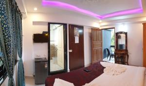 a bedroom with a bed and a room with a table at Veronica By The Beach Calangute in Calangute