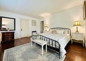 a bedroom with a bed and a table and a mirror at Green Villa in Shaughnessy - Free Parking - Pet-Friendly in Vancouver