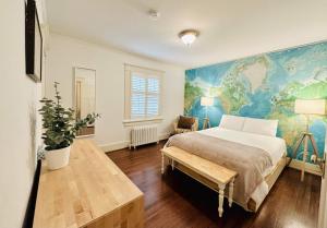 a bedroom with a large bed with a map on the wall at Green Villa in Shaughnessy - Free Parking - Pet-Friendly in Vancouver
