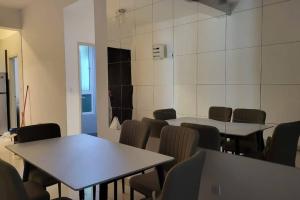 a room with tables and chairs and a wall with tiles at Stay@12 D'Festivo Residence Ipoh Perak in Ipoh
