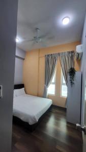 a small bedroom with a bed and a window at Stay@12 D'Festivo Residence Ipoh Perak in Ipoh