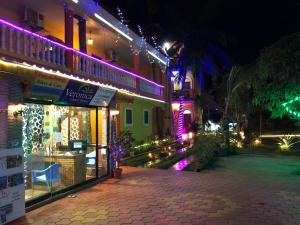 a building with purple and green lights on it at Veronica By The Beach Calangute in Calangute