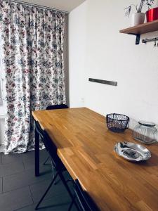 a wooden table in a room with a curtain at Spacious apartment in Zurich