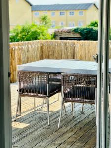 a table and two chairs sitting on a deck at Skøn villalejlighed i Skagen med terrasse og tæt på centrum in Skagen