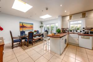 a kitchen with a table and a dining room at 5 bed Central Cambridge House in Cambridge
