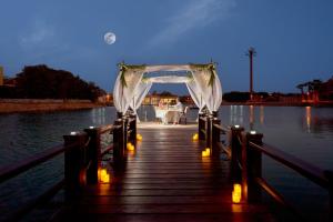 a wooden dock with a wedding arch on the water at Cook’s Club El Gouna (Adults Only) in Hurghada