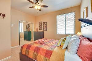 a bedroom with a bed and a ceiling fan at 5 Mi to State Farm Stadium Home with Private Pool! in Avondale +30 photos