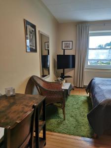 a bedroom with a bed and a desk and a table at Gästehaus Schu in Marpingen