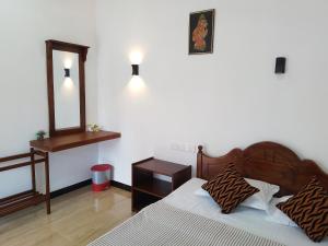 A bed or beds in a room at Nirwana Resort